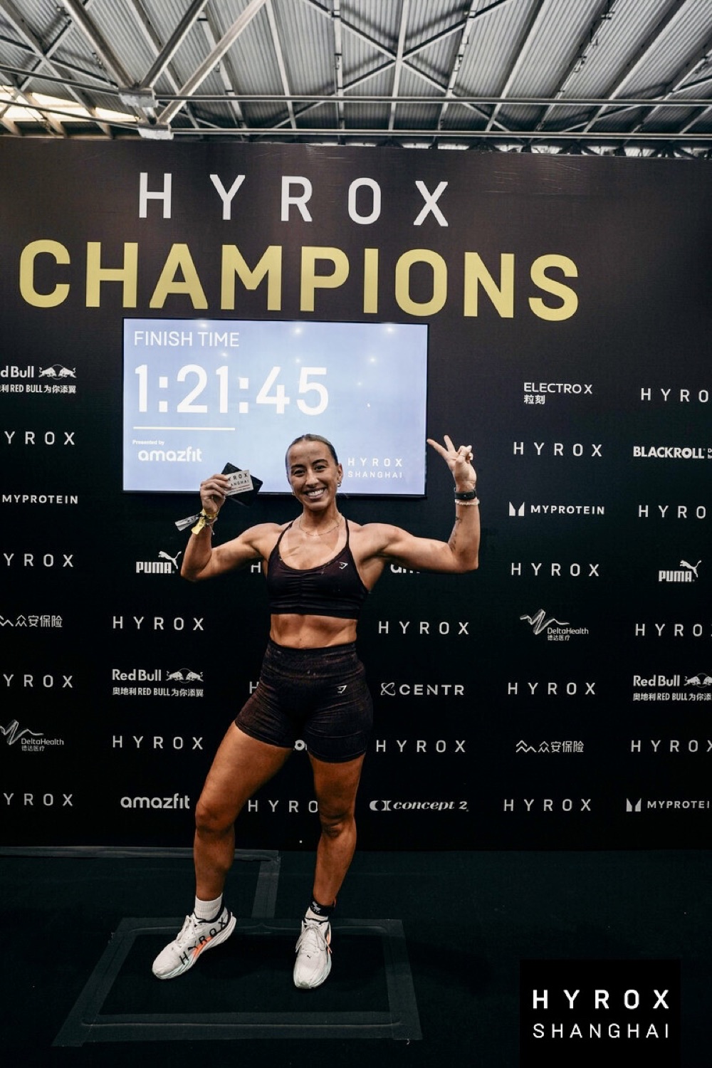 Megan Wills at HYROX Shanghai finish line with medal